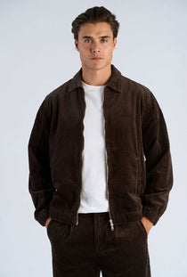 Front image of a model wearing the Seersucker corduroy zip jacket in brown, by brand Lindbergh