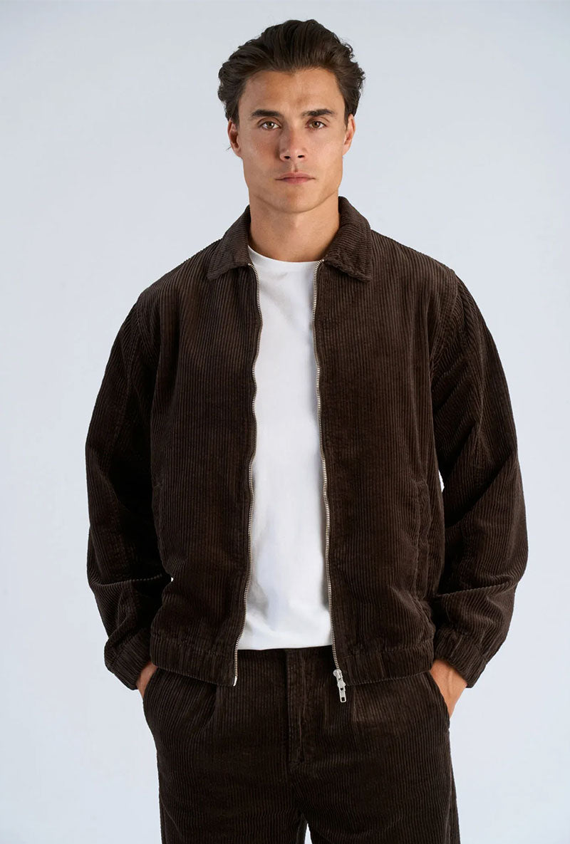 Front image of a model wearing Seersucker corduroy zip jacket in brown, by brand Lindbergh