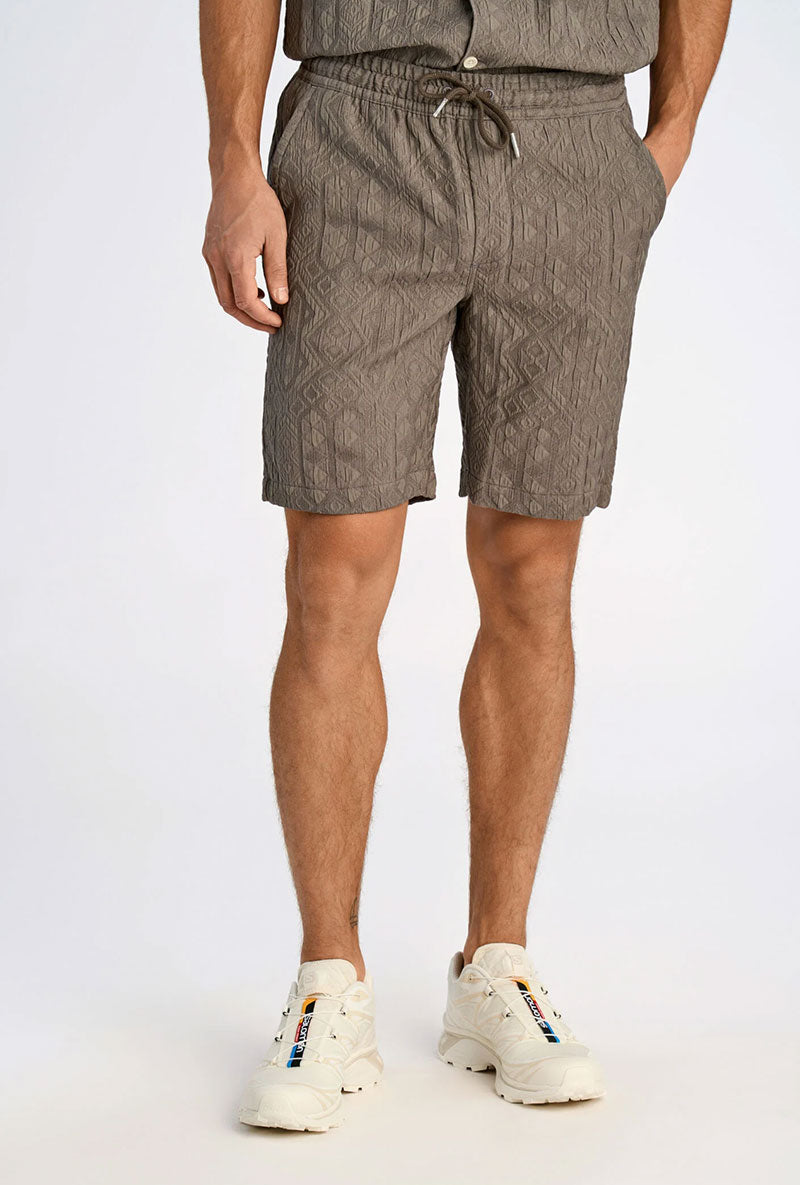 Front image of a model wearing Textured shorts in khaki, by brand Lindbergh