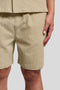 Front image of a model wearing the Crinkle resort shorts in stone, by brand Lyle and scott