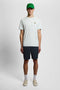 Front image of a model wearing the Everyday shorts in navy, by brand Lyle and scott