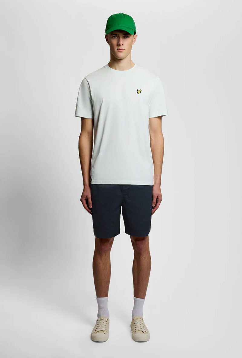 Front image of a model wearing Everyday shorts in navy, by brand Lyle and scott