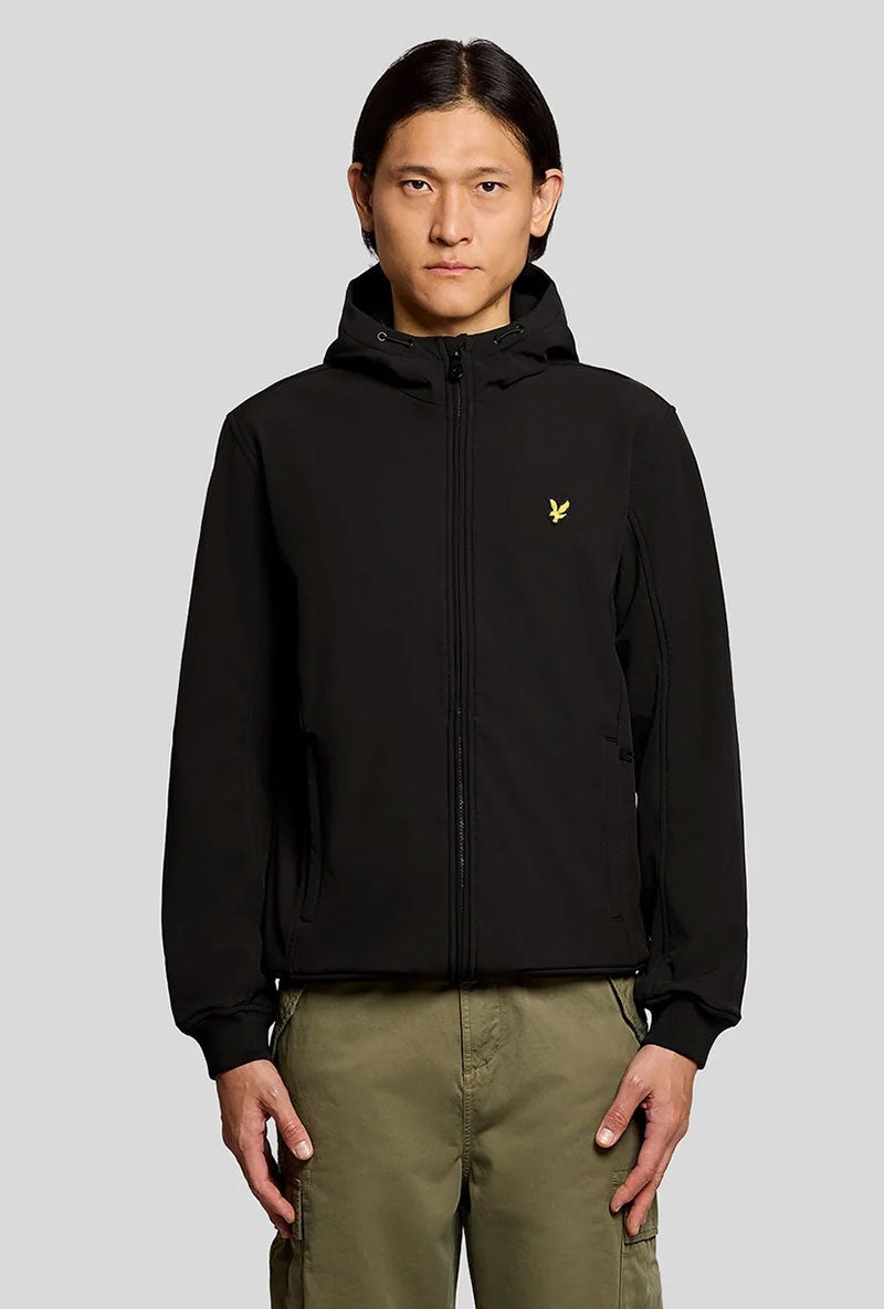 Front image of a model wearing Fleece back softshell jacket in black, by brand Lyle and scott