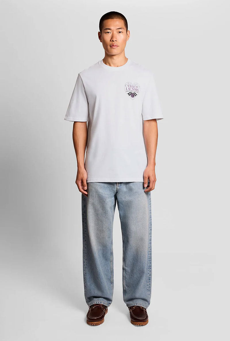 Front image of a model wearing Lyles laundry graphic t in white, by brand Lyle and scott