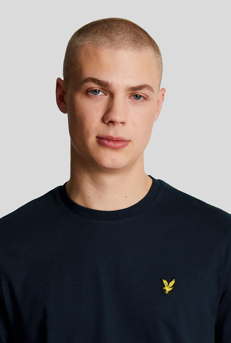 Front neck detail image of a model wearing Plain logo tshirt in navy, by brand Lyle and scott
