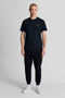 Front image of a model wearing the Plain logo tshirt in navy, by brand Lyle and scott