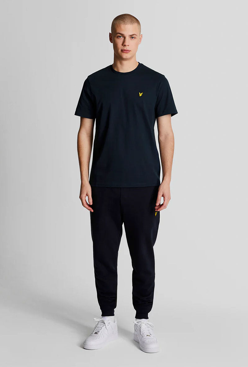 Front image of a model wearing Plain logo tshirt in navy, by brand Lyle and scott
