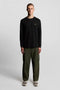 Front image of a model wearing the Plain ls tshirt in black, by brand Lyle and scott