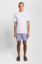 Front image of a model wearing the Plain swimshorts in blue, by brand Lyle and scott