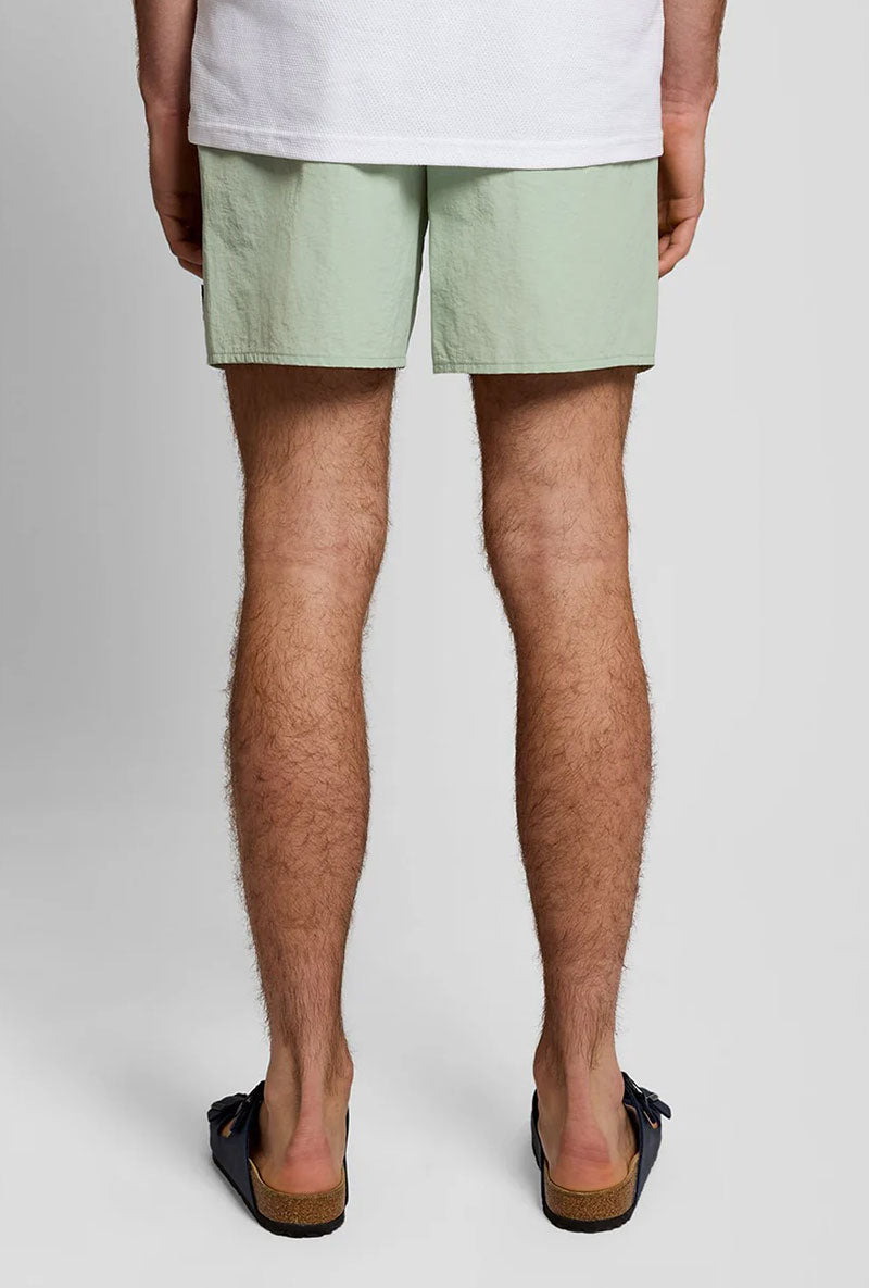 Back image of a model wearing Plain swimshorts in sage, by brand Lyle and scott