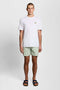 Front image of a model wearing the Plain swimshorts in sage, by brand Lyle and scott