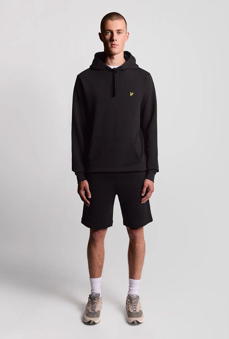 Front image of a model wearing Sweat shorts in black, by brand Lyle and scott