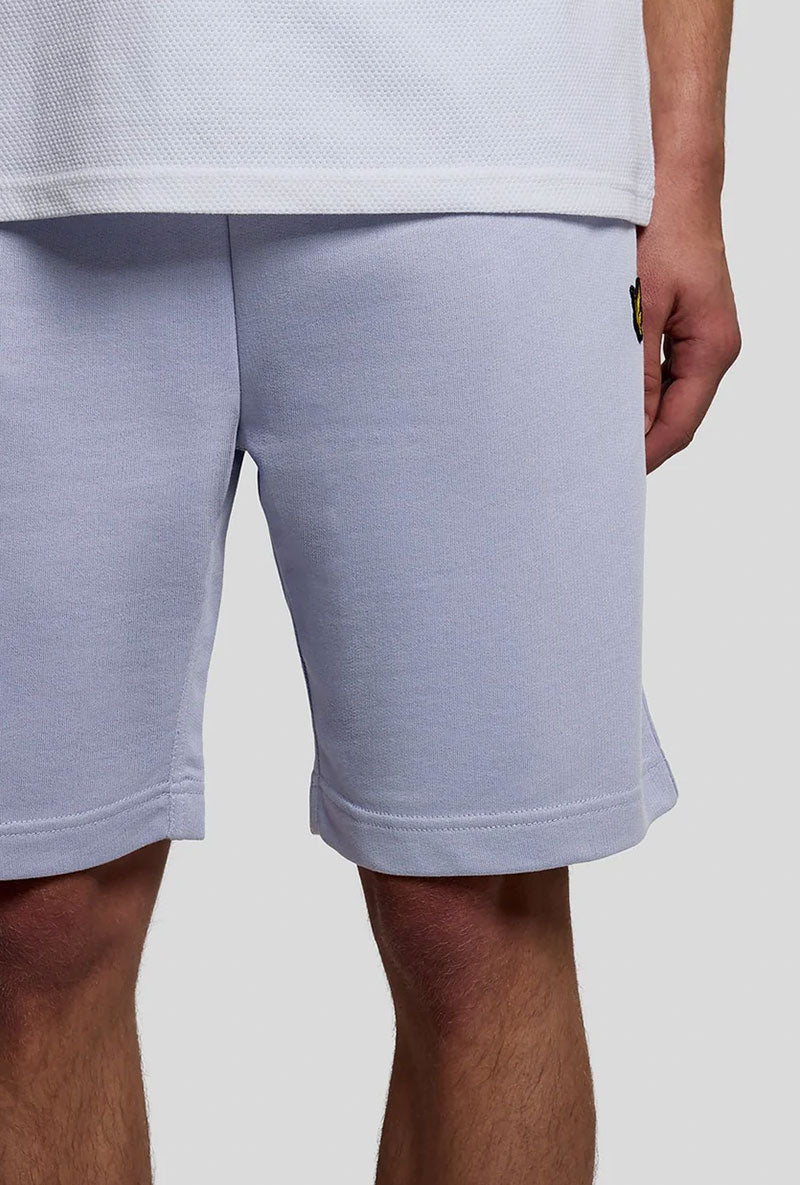Front detail image of a model wearing Sweat shorts in blue, by brand Lyle and scott