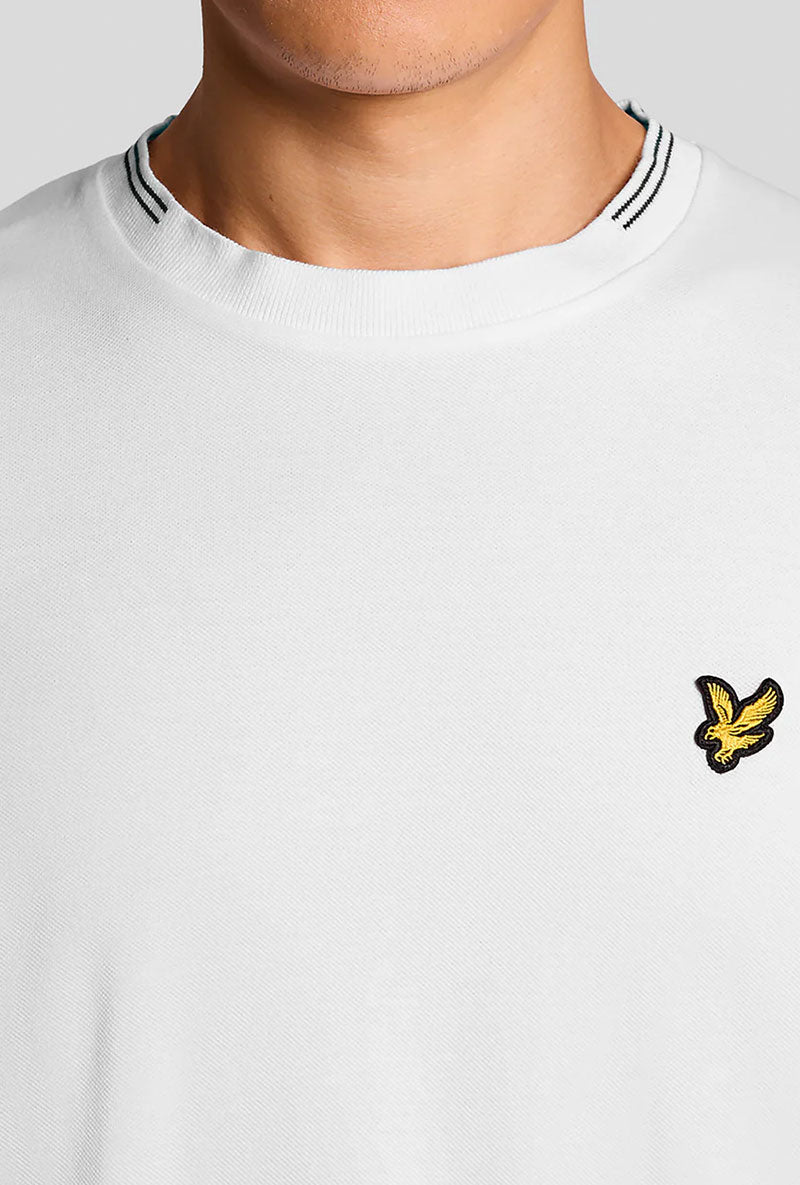 Front detail image of a model wearing Fine tipped t in white, by brand Lyle and scott