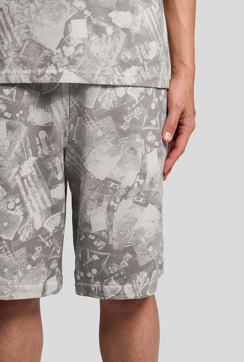Front detail image of a model wearing Industrial print sweat shorts in grey, by brand Lyle and scott