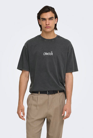 Front image of a model wearing the Fred creative washed tee in black, by brand Only and sons