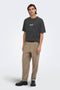 Front image of a model wearing the Fred creative washed tee in black, by brand Only and sons