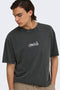 Front image of a model wearing the Fred creative washed tee in black, by brand Only and sons