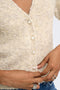Front image of a model wearing the Bouble ss vneck button cardigan in stone, by brand Only