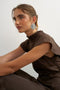 Front image of a model wearing the Cilly sation flippy hem mini dress in chocolate, by brand Top shop