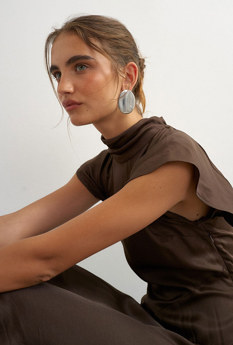 Front image of a model wearing Cilly sation flippy hem mini dress in chocolate, by brand Top shop