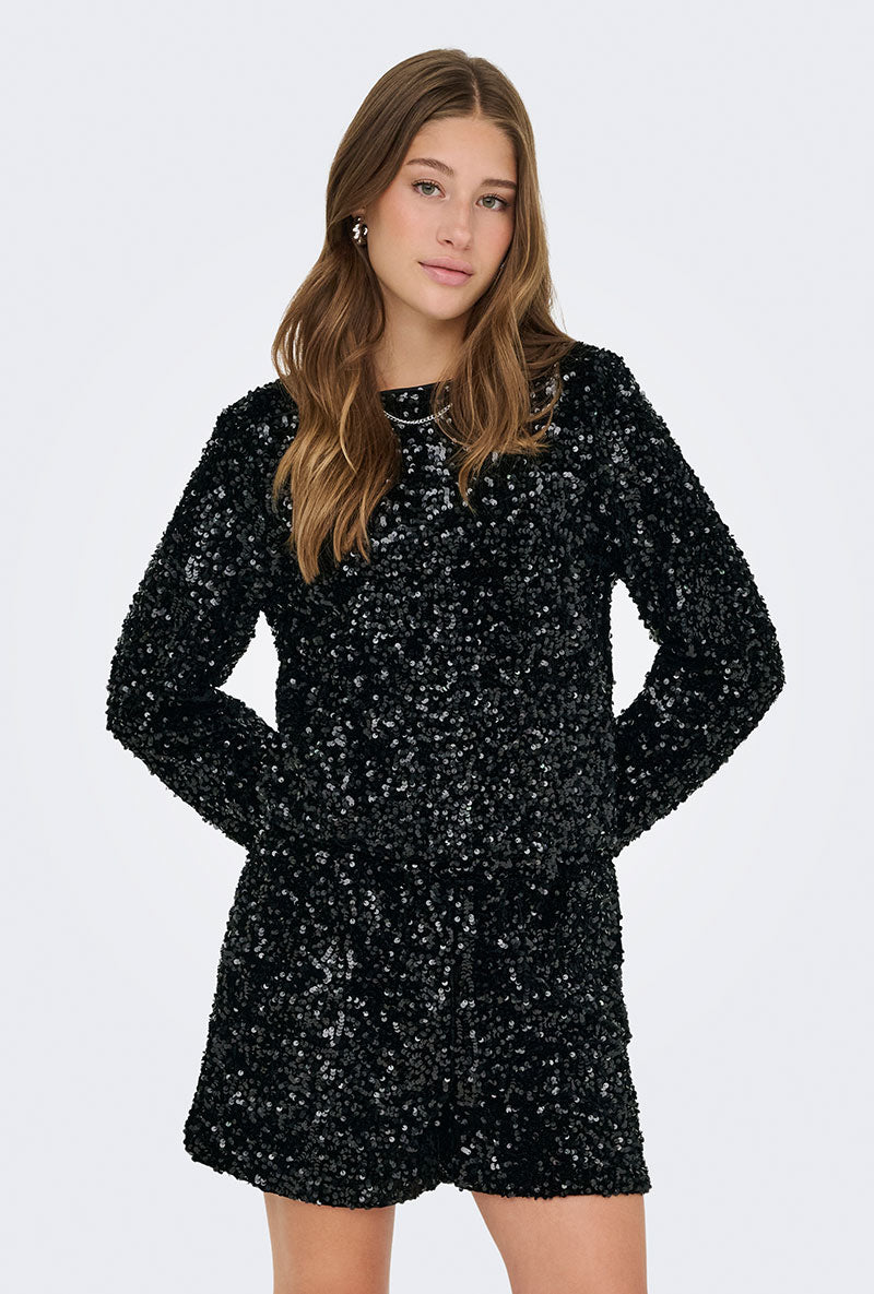 Front image of a model wearing Confidence ls sequin bow top in black, by brand Only