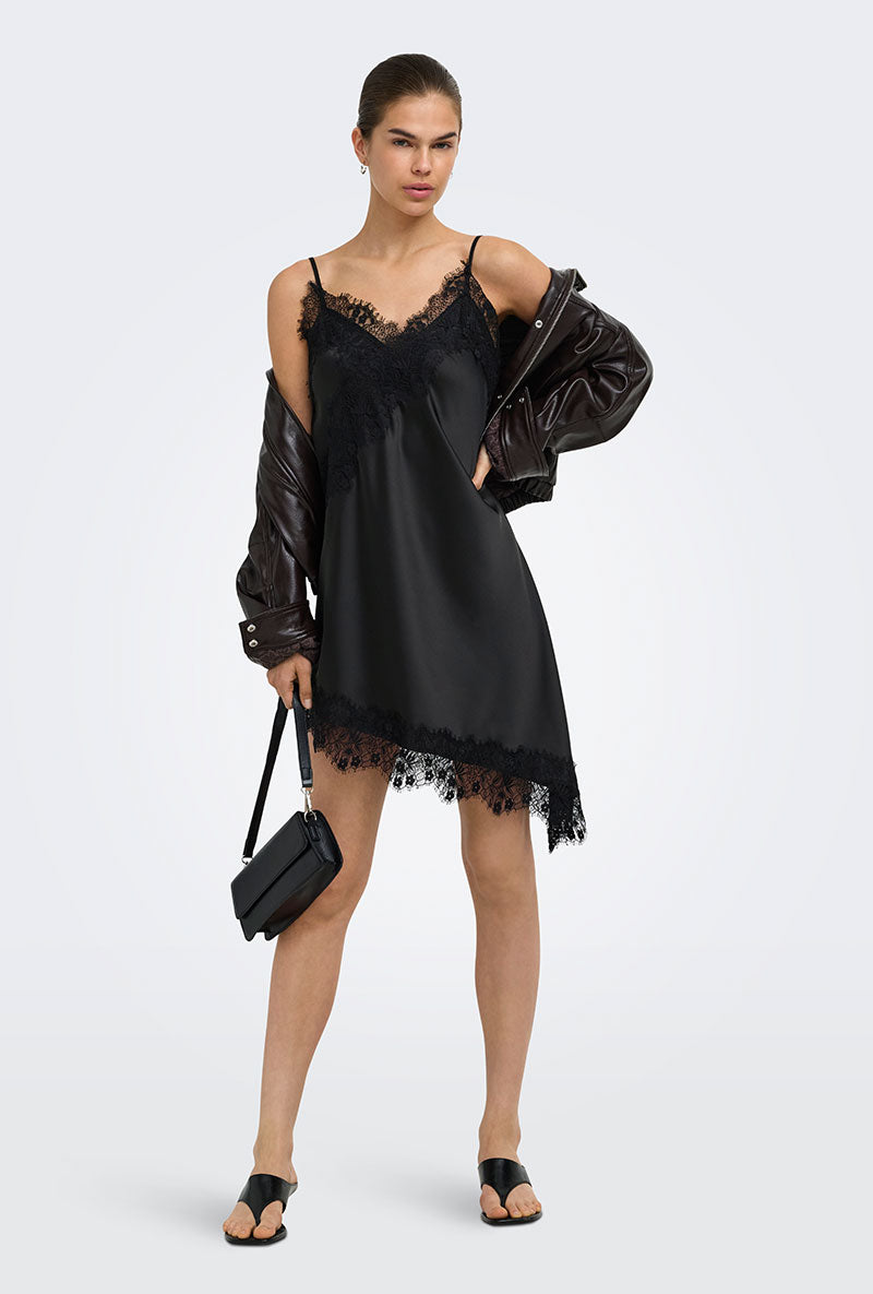 Front image of a model wearing Lindona strap satin lace dress in black, by brand Only