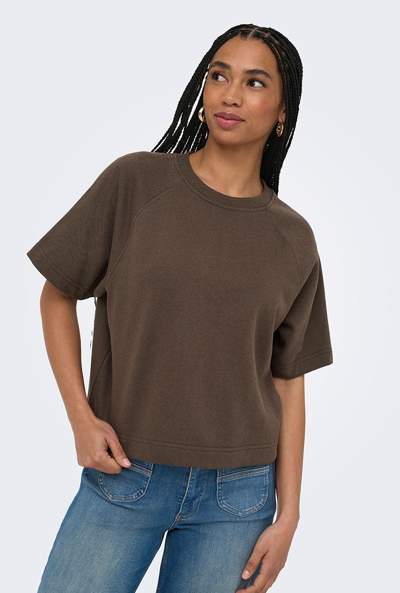 Front image of a model wearing Ofelia ss raglan sweatshirt in brown, by brand Only