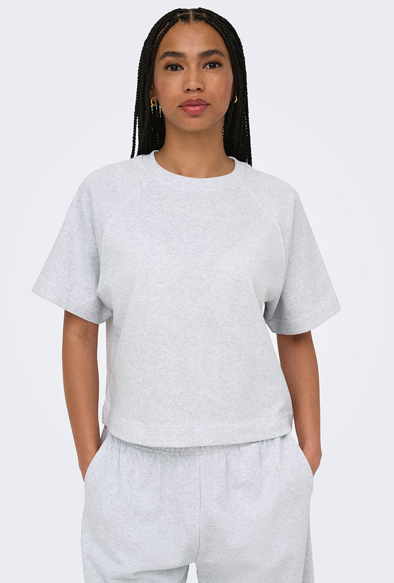 Front image of a model wearing Ofelia ss raglan sweatshirt in light grey, by brand Only