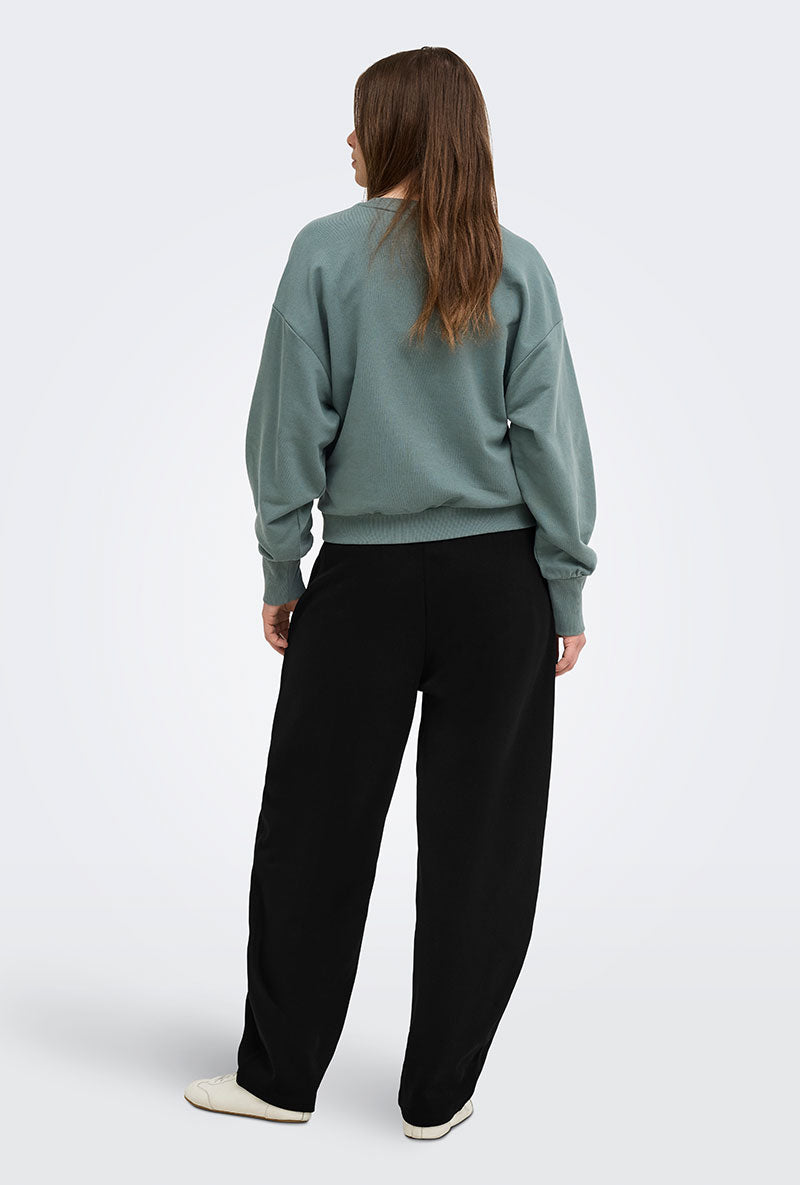 Back image of a model wearing Ofelia sweatpants in black, by brand Only