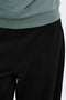 Front image of a model wearing the Ofelia sweatpants in black, by brand Only