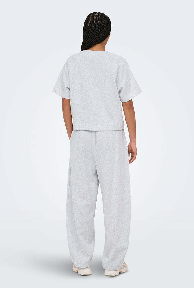 Back image of a model wearing Ofelia sweatpants in light grey, by brand Only