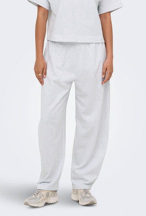 Front image of a model wearing Ofelia sweatpants in light grey, by brand Only
