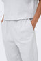 Front image of a model wearing the Ofelia sweatpants in light grey, by brand Only