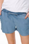 Front image of a model wearing the Pema life lycell denim shorts in denim, by brand Only