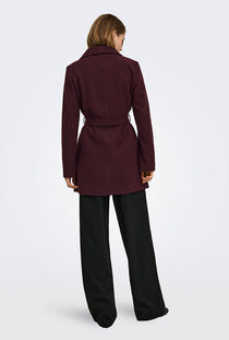 Back image of a model wearing the Trish wrap coat in chocolate, by brand Only