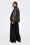 Back image of a model wearing the Yasmine mw pleat barrel pant in black, by brand Only