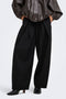 Front image of a model wearing Yasmine mw pleat barrel pant in black, by brand Only