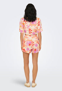 Back image of a model wearing the Only zuffy life shorts in orange, by brand Only