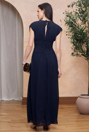Back image of a model wearing the Angelie maxi dress in navy, by brand Tfnc