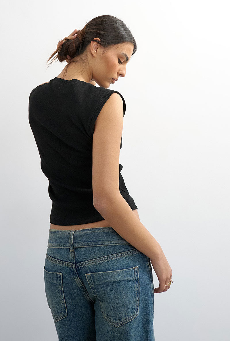Back image of a model wearing Adela sl rib boyfriend tank top in black, by brand Top shop