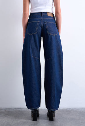 Back image of a model wearing the Barrel hr denim jeans in dark denim, by brand Top shop