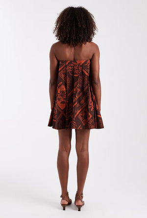 Back image of a model wearing the Calla bandeau mini dress in rust, by brand Top shop