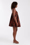 Front image of a model wearing the Calla bandeau mini dress in rust, by brand Top shop
