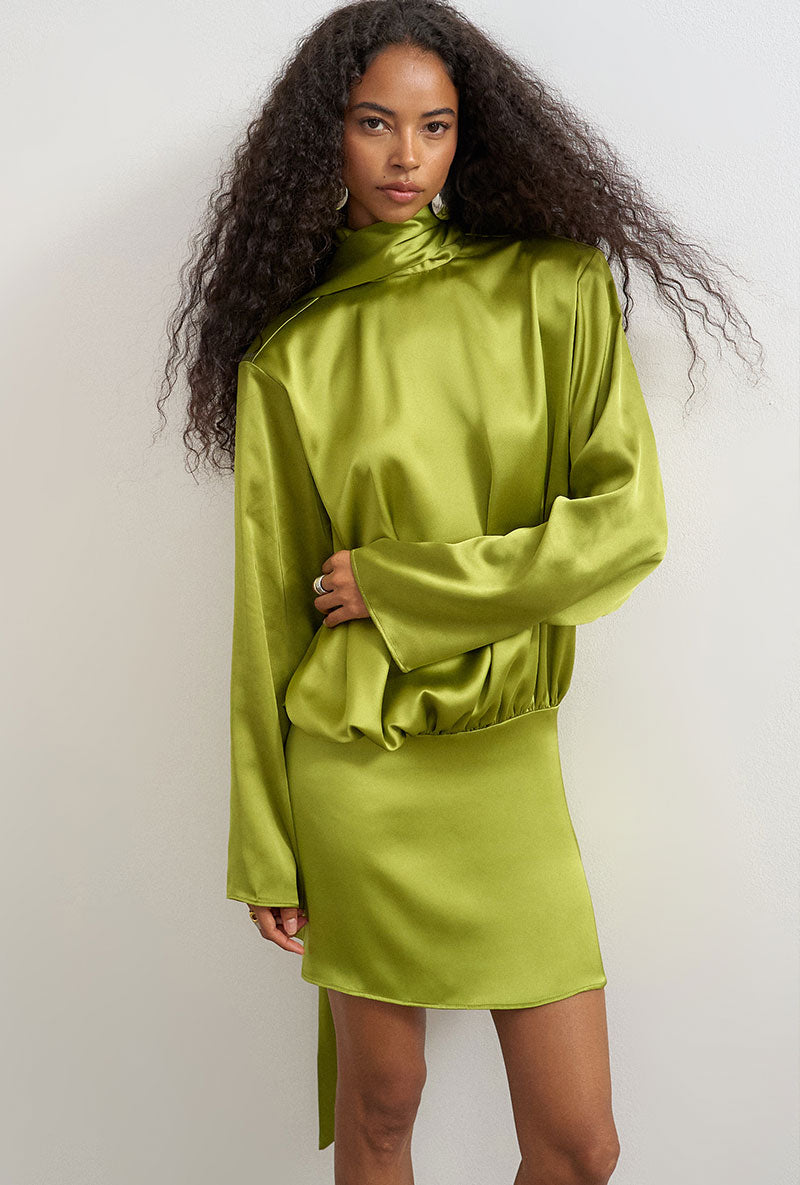 Front image of a model wearing Ceren satin scarf tie mini dress in green, by brand Top shop