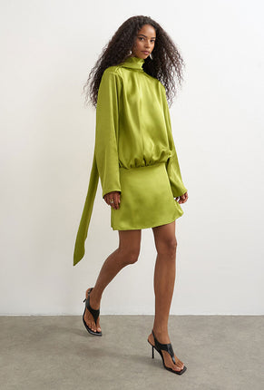 Front image of a model wearing Ceren satin scarf tie mini dress in green, by brand Top shop