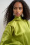 Front image of a model wearing the Ceren satin scarf tie mini dress in green, by brand Top shop