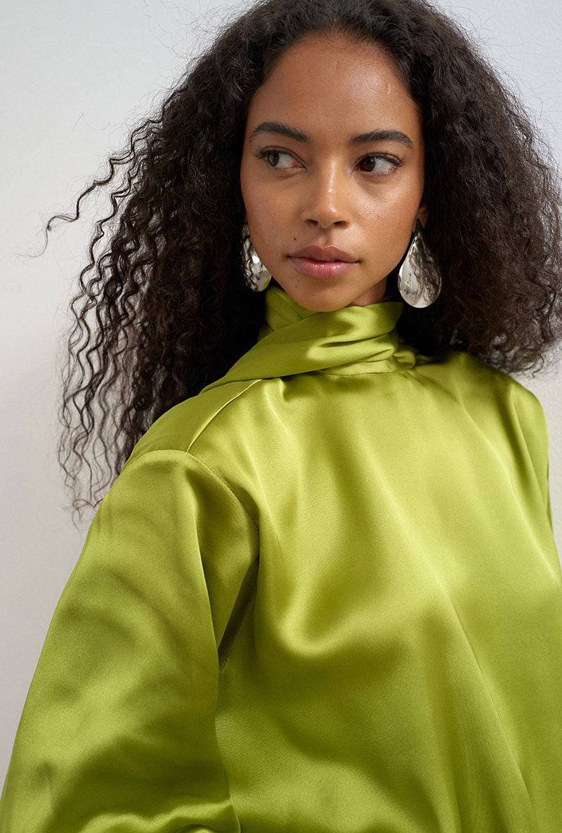 Front image of a model wearing Ceren satin scarf tie mini dress in green, by brand Top shop