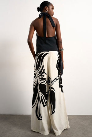 Back image of a model wearing the Fiona wide leg trousers in off white, by brand Top shop