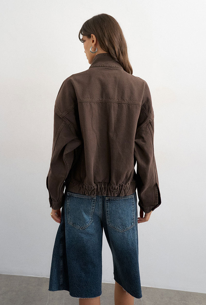 Back image of a model wearing Freya denim jacket in brown, by brand Top shop